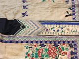 an image of a bed covered in a blue and white bedspread