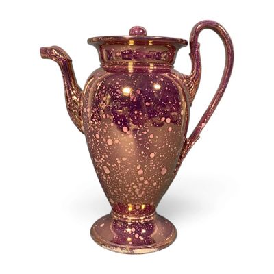 a purple vase that is sitting on a white surface