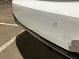 a close up of a car ' s bumper with a hole in it