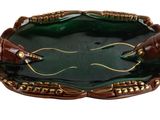 a green and gold plate with two crabs on it
