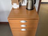 a wooden dresser with a kettle on top of it