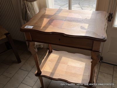 a wooden table with a drawer on it in front of a window
