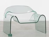 a glass table with a curved design on top of it