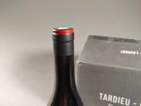 a bottle of wine next to a box on a table