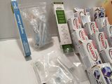 many toothbrushes and toothpaste packages on the counter