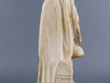 an image of a statue of a man with a hat and cloak