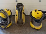 three vacuum cleaners are lined up in front of a garage door
