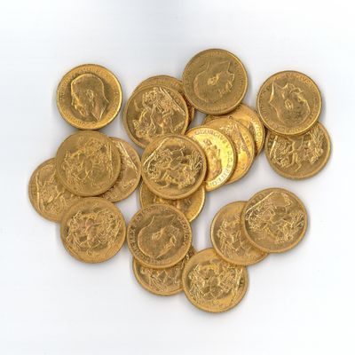 a pile of gold coins sitting on a white surface