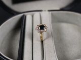 a black and white diamond ring in a white box