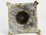 a small metal object with a hole in the middle of it