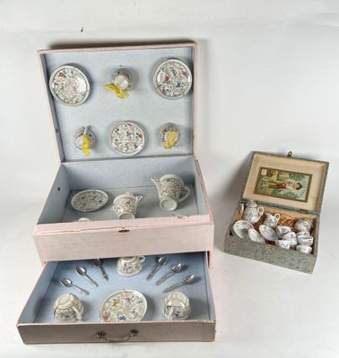 two boxes with silverware in them on a white surface