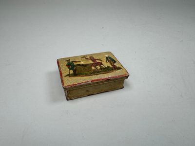 a small box with a painting on it on a table