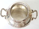 a silver bowl with handles on a white surface