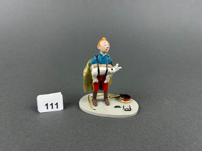 the figurine of a man with a dog is posed next to a number 11
