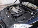 a black car with its hood open on the street