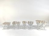 eight wine glasses lined up on a white table