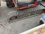 a small tractor that is parked in a lot