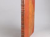 an old book sitting on top of a table with a white background