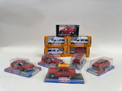 six toy cars in a display case on a white surface