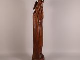 an image of a wooden statue of a woman holding a child