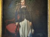 portrait of a young girl in a black dress with a red chair and a red chair