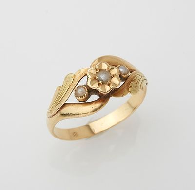 a gold ring with a flower and leaves design