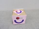 a pink box with a smiley face painted on it
