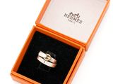 a box with a ring inside of it on a white surface
