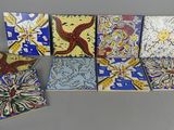 six pieces of colorful tile sitting on top of a table