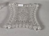 pair of glass candlestick holders with ornate designs on each side