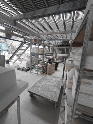 a room that has a lot of shelves and a table in it