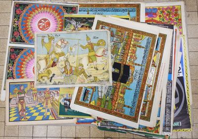 a pile of art on the floor of a tiled floor