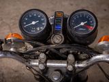 two gauges on the handlebars of a motorcycle