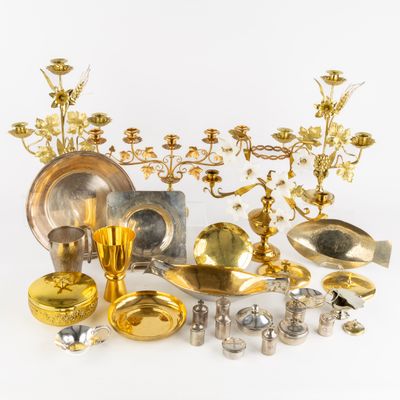 a lot of gold and silver items on a white surface