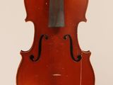 an old violin with a bow hanging from it ' s back