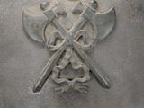 a metal helmet with two crossed axes on it