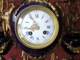 a blue and gold clock sitting on a table