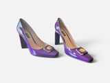 a pair of purple high heels with a cat on the heel