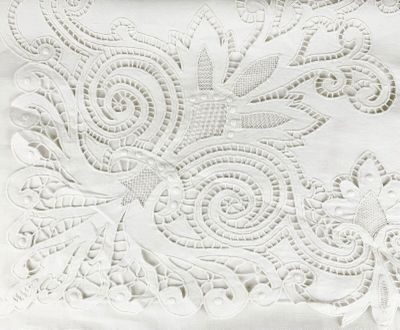 embroidered white fabric with a floral design on top of it