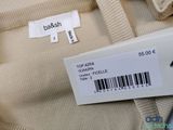 the back of a beige shirt with a barcode on it