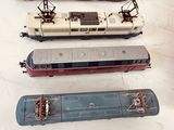 three trains sitting on a table next to each other