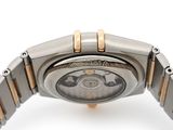 a close up of a watch on a white surface