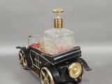 a black and gold car with a bottle on top of it