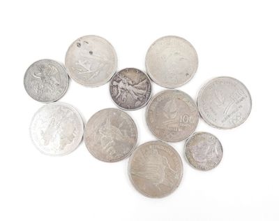 a lot of coins that are on a white surface