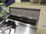 a fish tank sitting on top of a stainless steel counter
