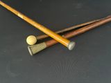 two baseball bats and a ball on a table