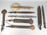 many different types of knives on a white surface