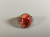 an image of a ring with a red stone in it