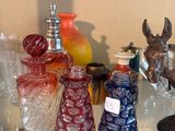 a glass shelf filled with glass vases and other glass items