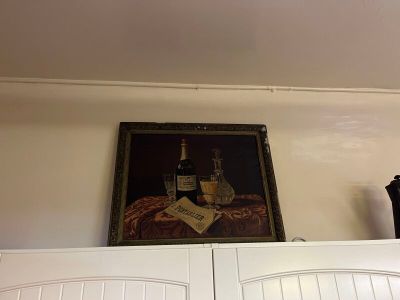 une photo d'un tableau accroché au mur au-dessus d'un meuble